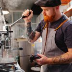 barista preparing coffee machine during work